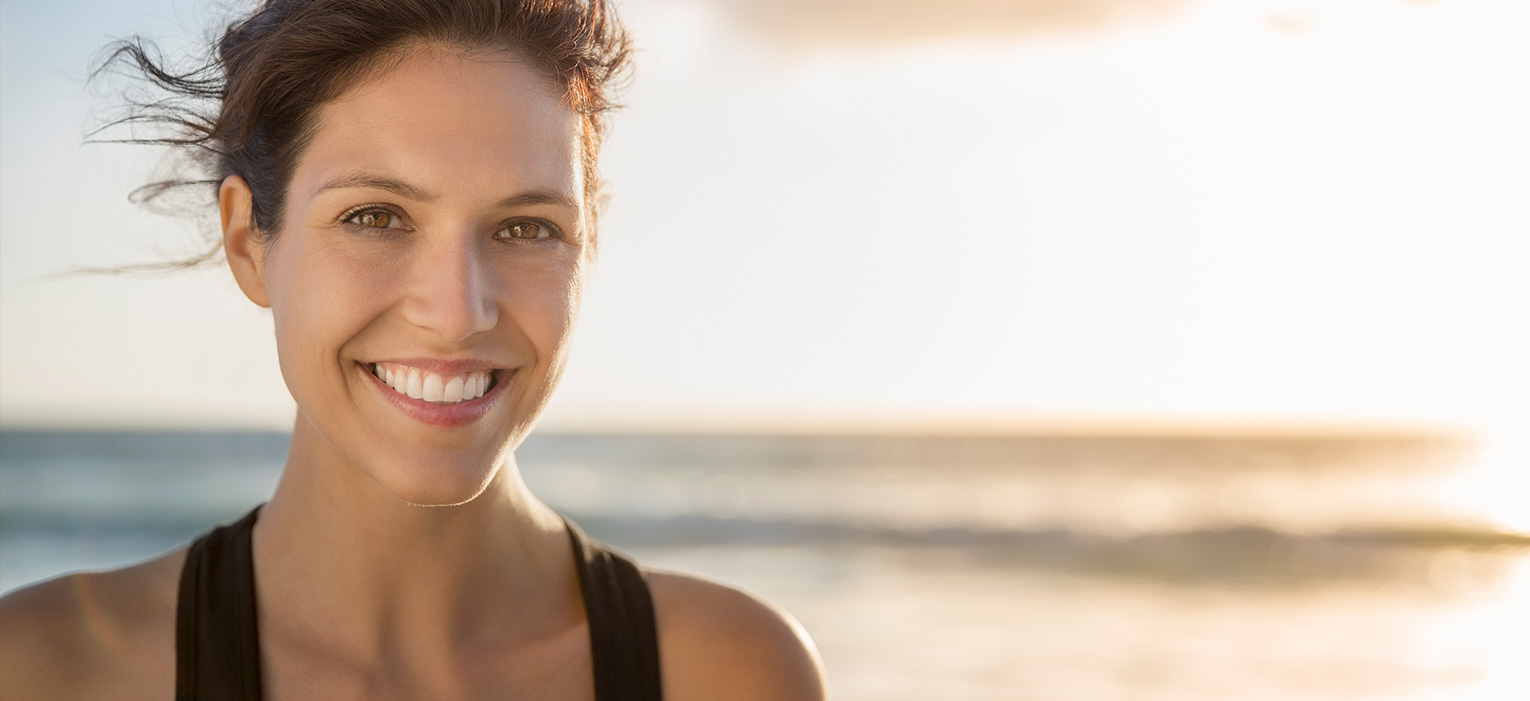 Woman on beach smiling